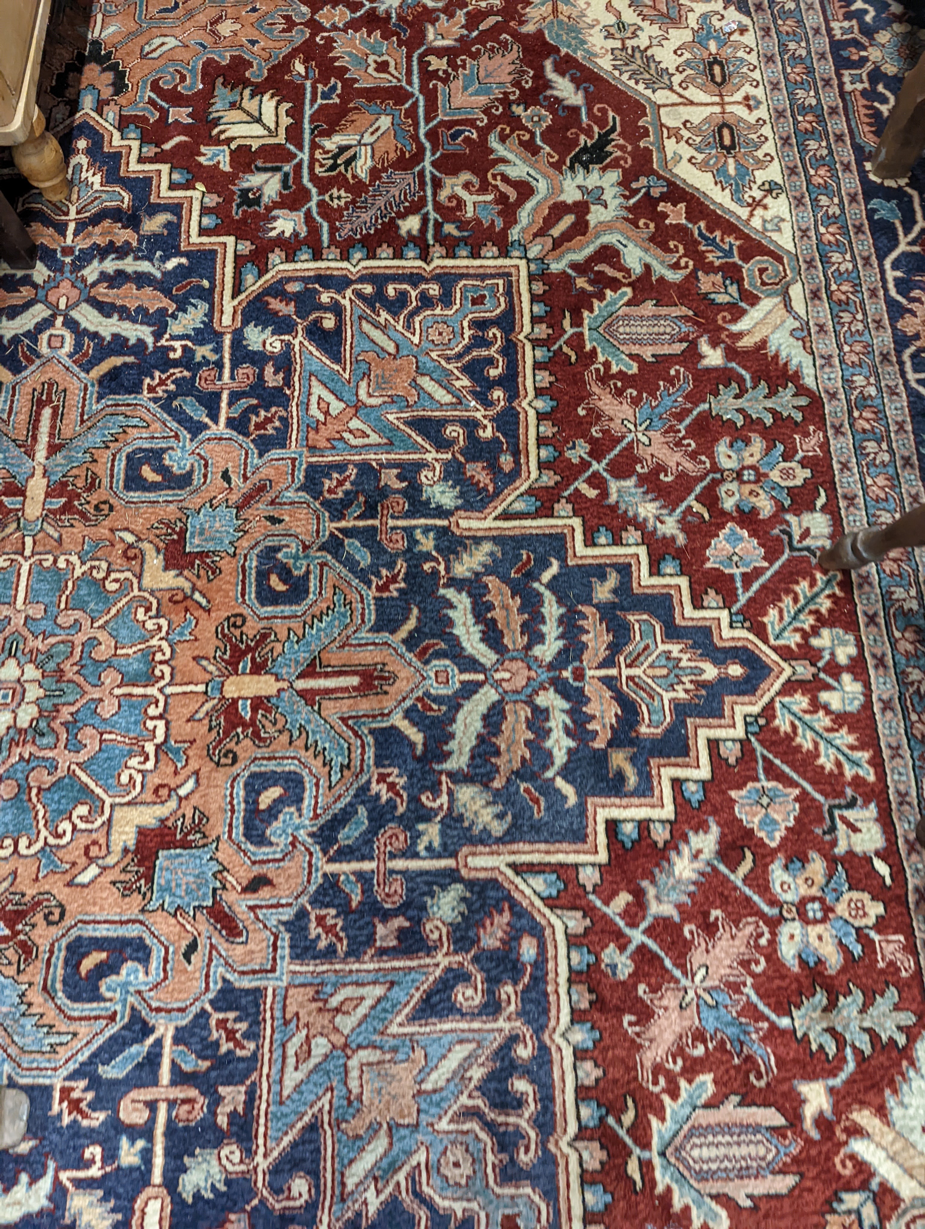 A large Caucasian style red ground carpet, 460 x 330cm